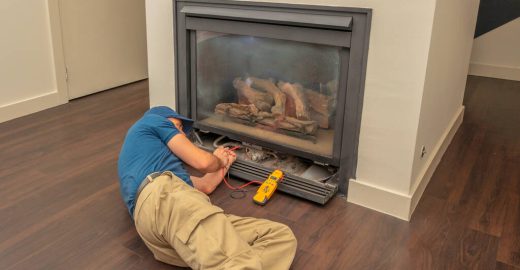 Service technician working on a fireplace